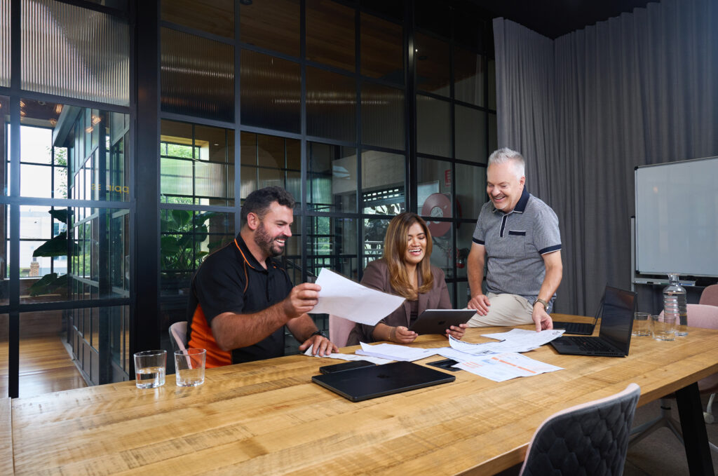 Standish Co team collaborating on financial documents and business strategy in modern office meeting